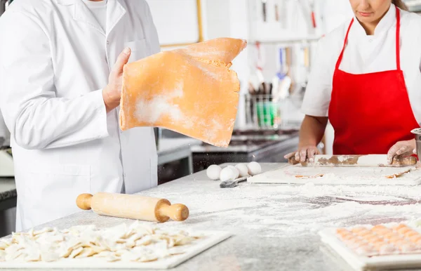 Midsection Of Chefs Preparing Ravioli Pasta At Kitchen Counter — Stock Photo, Image