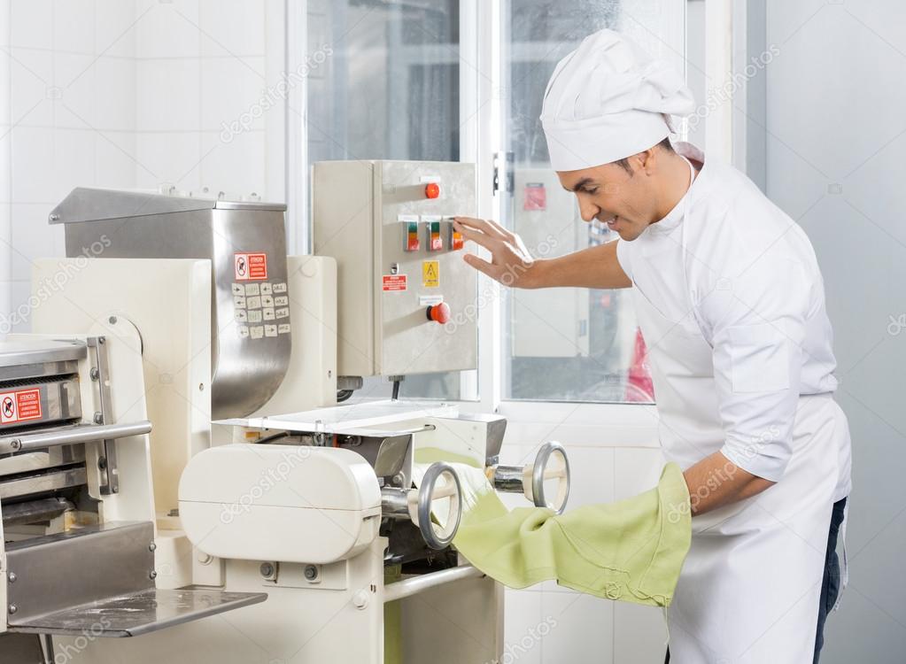 Smiling Chef Operating Spaghetti Pasta Machine