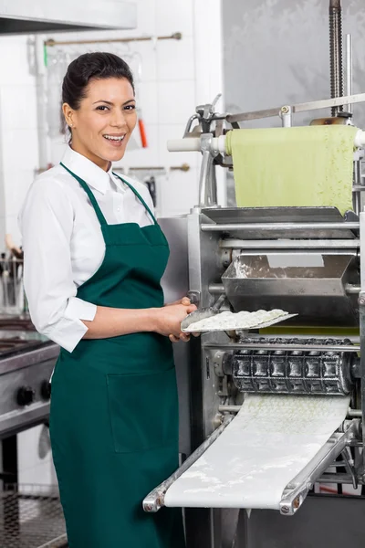 Gelukkig vrouwelijke chef-kok bedrijf Ravioli Pasta lade door Machine — Stockfoto