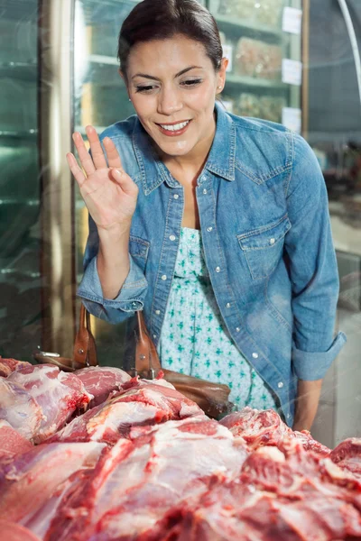 Donna che compra carne in macelleria — Foto Stock