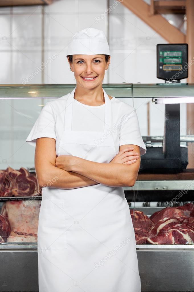 Happy Female Butcher In Shop