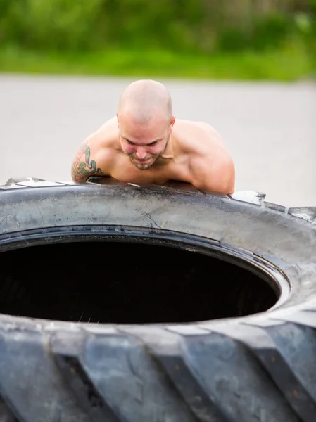 Male Athlete Lifting Truck Tire — Stock Photo, Image