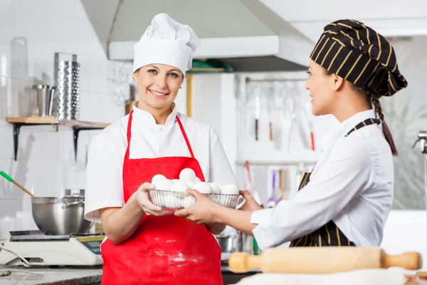 Happy Chef Giving Container Full Of Eggs To Colleague — Stock Photo, Image