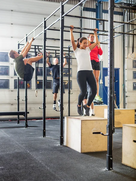 Athletes Exercising On Gymnastic Bars — Stock Photo, Image