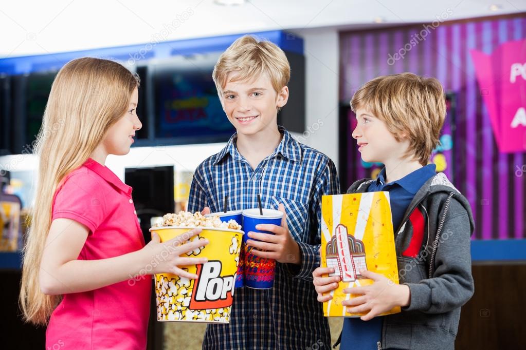 Siblings Holding Snacks At Cinema
