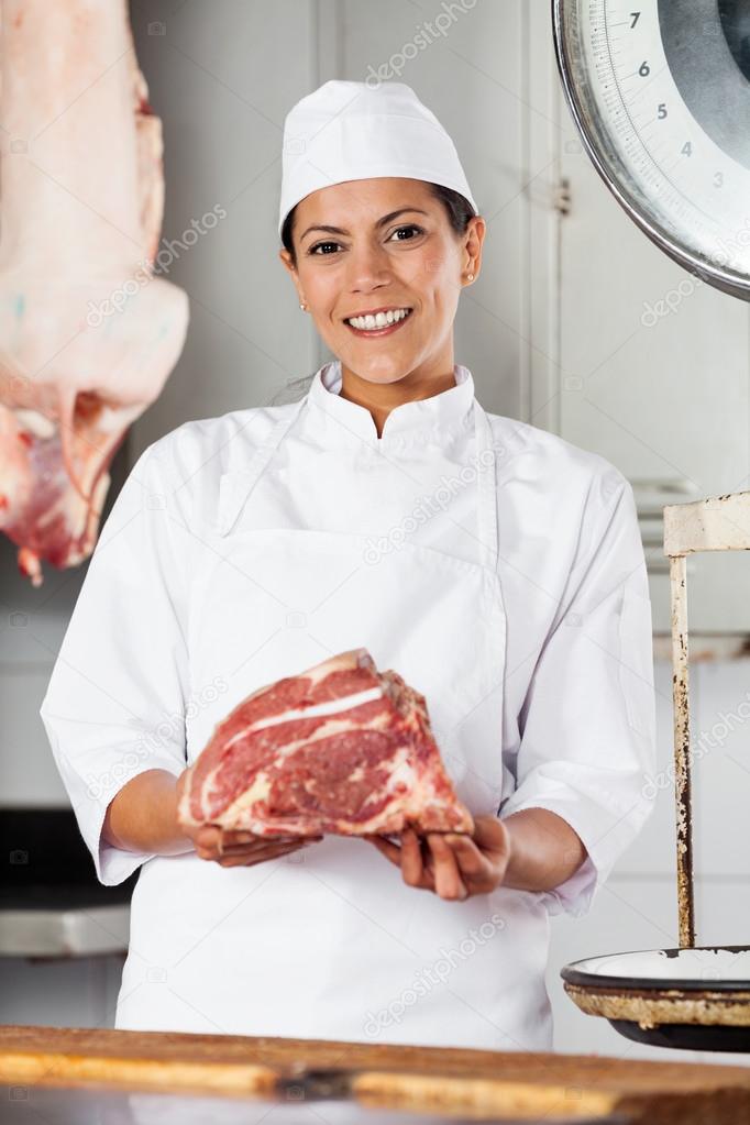 Confident Female Butcher Holding Red Meat