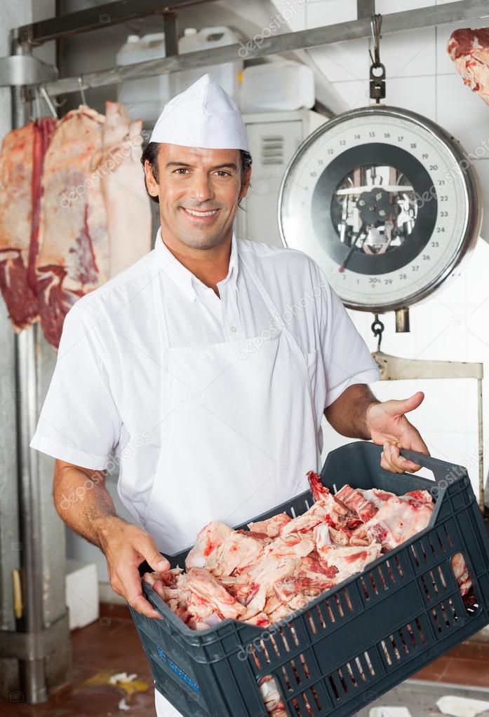 Butcher Carrying Crate Full Of Meat Pieces