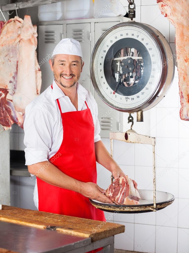 Happy Butcher Weighing Meat On Scale