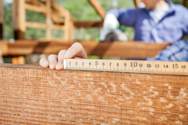 Architects Hand Measuring Wood At Site — Stock Photo, Image