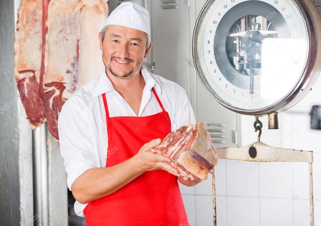Butcher Holding Meat In Butchery