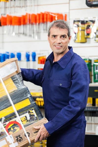 Arbeiter trägt Werkzeugpaket im Baumarkt — Stockfoto
