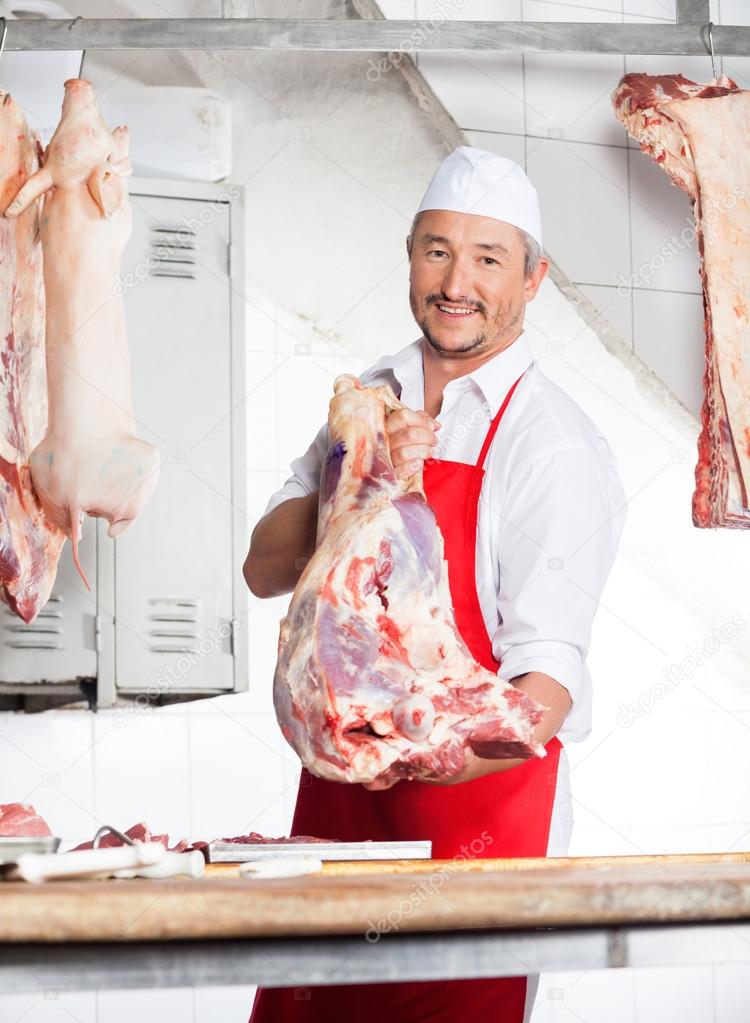 Butcher Carrying Meat In Butchery