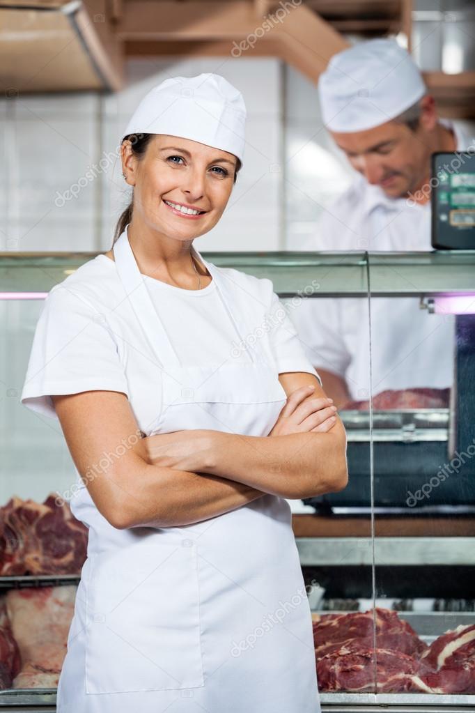 Confident Butcher With Colleague Working In Store