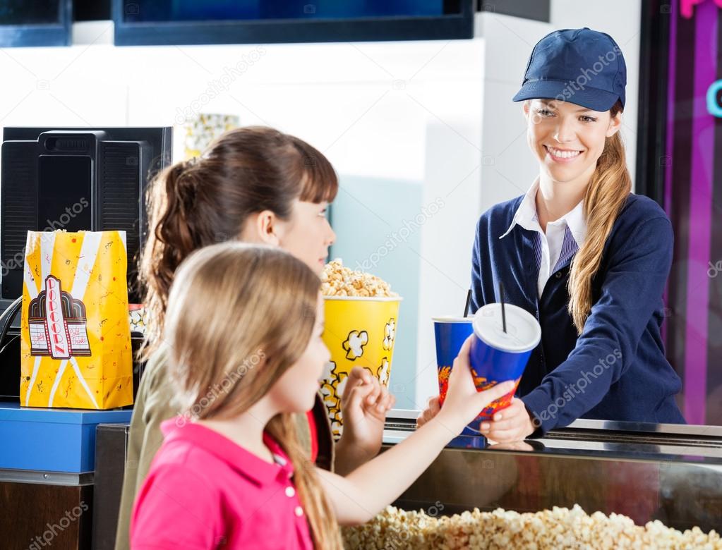 Sisters Buying Snacks From Concession Worker At Cinema