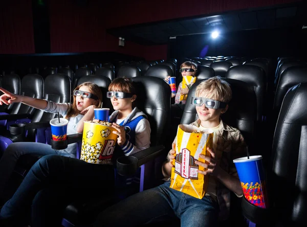 Irmãos fazendo lanches no cinema 3D — Fotografia de Stock