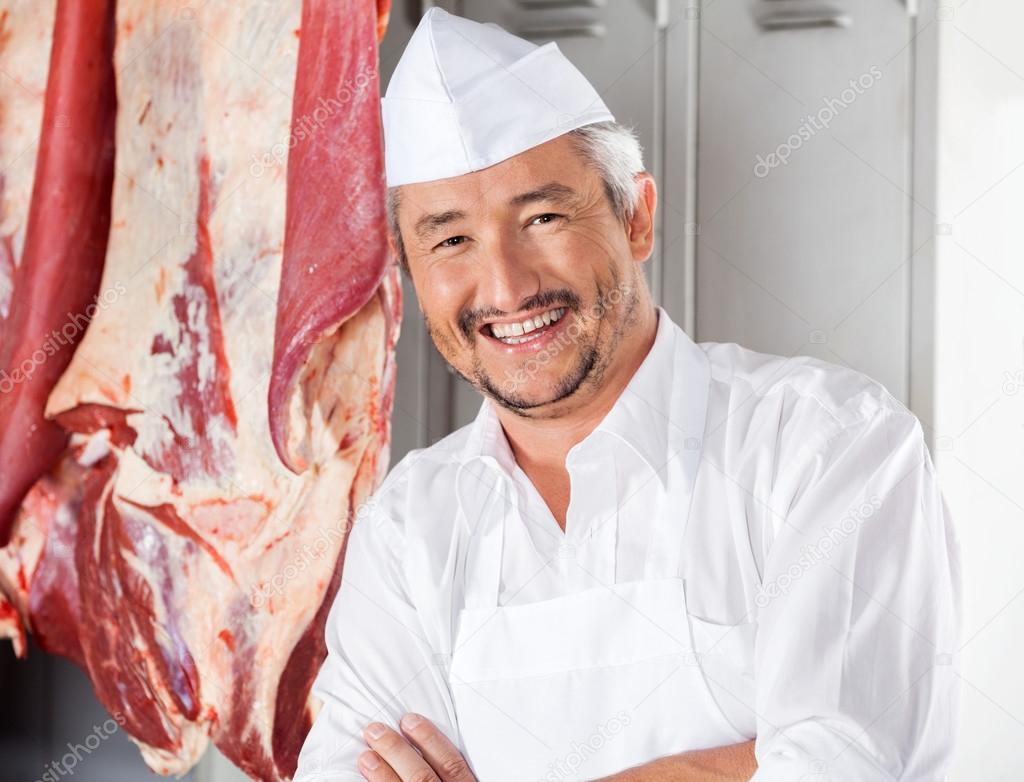 Confident Butcher Smiling In Slaughterhouse
