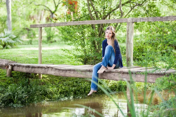 Thoughtful Woman Sitting On Wooden Bridge — Stock Photo, Image