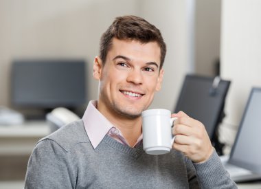 Smiling Employee Having Coffee In Call Center