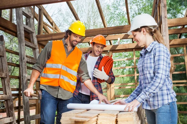 Architects Analyzing Blueprint In Wooden Cabin — Stock Photo, Image