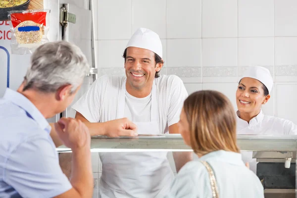 Bouchers regardant le client dans la boutique — Photo