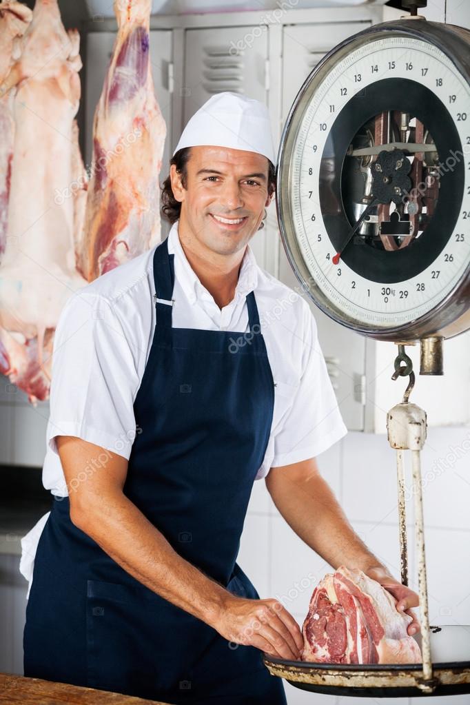 Confident Butcher Weighing Meat On Machine