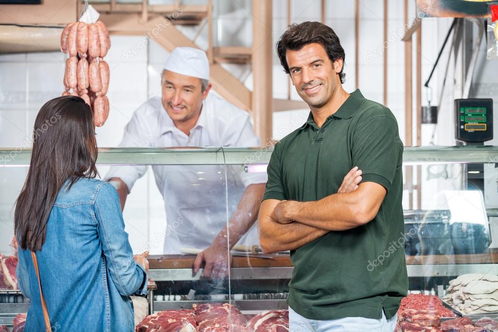 Happy Man With Woman Buying Meat At Butchery