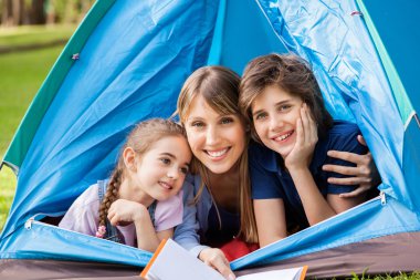 Mother With Children Camping In Park clipart
