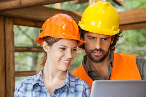 Arquitectos usando el ordenador portátil en el sitio de construcción — Foto de Stock