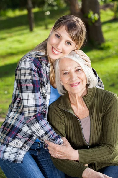 Woman Embracing Mother At Campsite — Stock Photo, Image