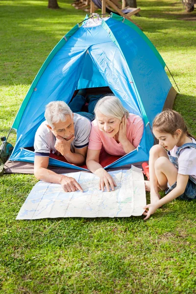 Grandparents With Granddaughter Studying Map At Campsite — Stock Photo, Image