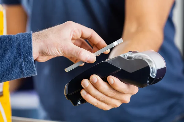 Homme payant par la technologie NFC au cinéma — Photo