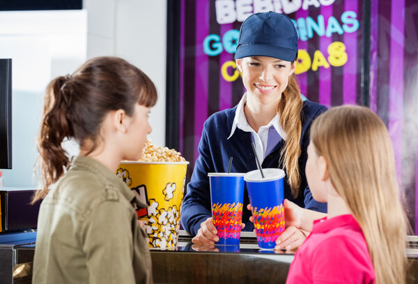 Worker Selling Snacks To Girls At Concession Counter