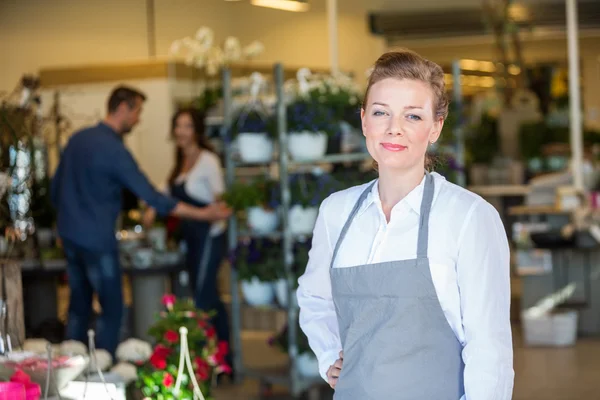 Portrait Of Confident Salesperson In Flower Shop Stock Photo