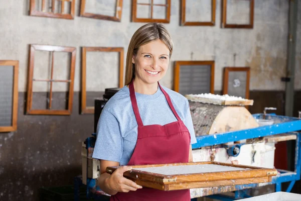 Kvinnlig arbetare håller mögel på pappers-fabriken — Stockfoto