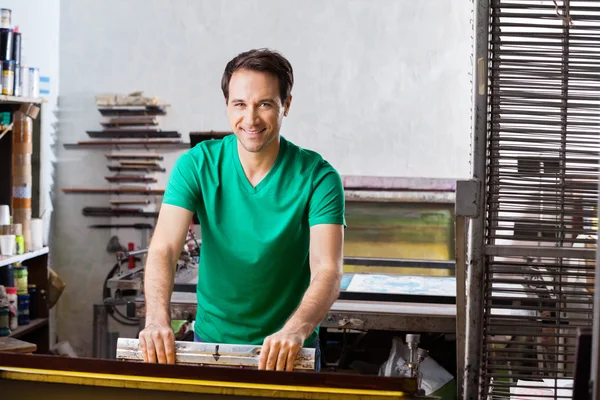 Confident Worker Using Squeegee In Paper Factory — Stock Photo, Image