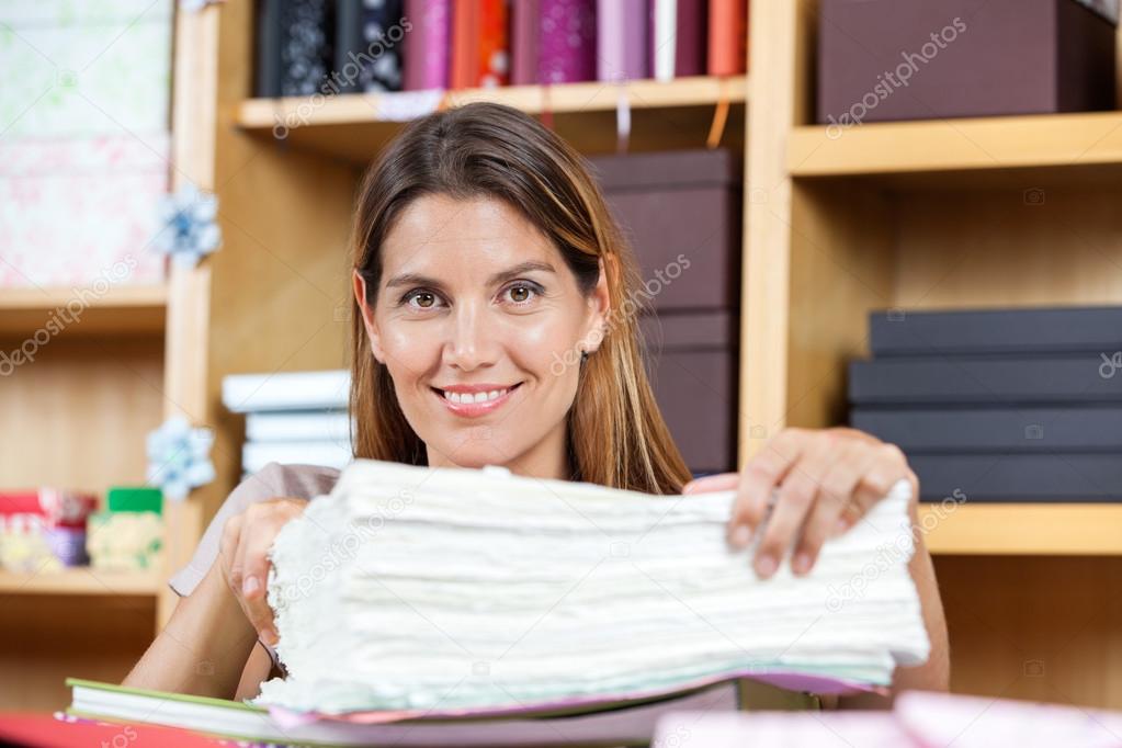 Mid Adult Saleswoman With Papers In Store