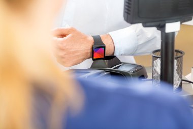Midsection müşterinin Smartwatch eczane aracılığıyla ödeme