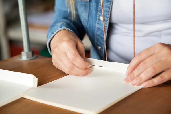 Closeup Of Worker Inserting Needle In Paper — Stock Photo, Image