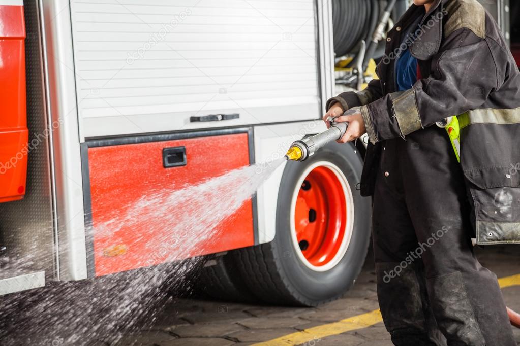 Firewoman Spraying Water During Training