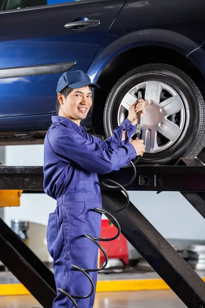 Lleno mecánico de aire en el neumático del coche en el garaje —  Fotos de Stock