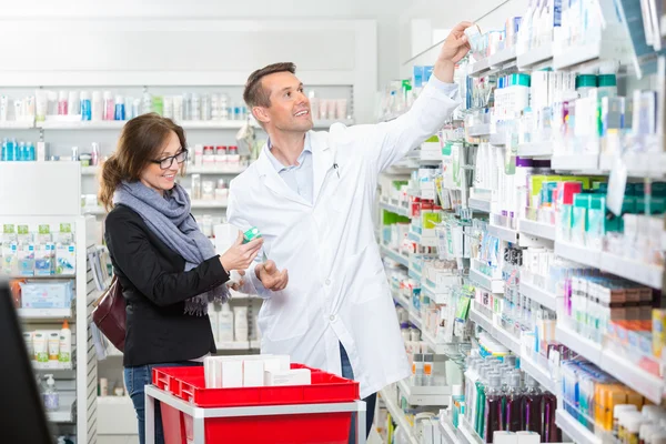 Kémikus, a Labcoat eltávolítása a gyógyszer női vevő — Stock Fotó