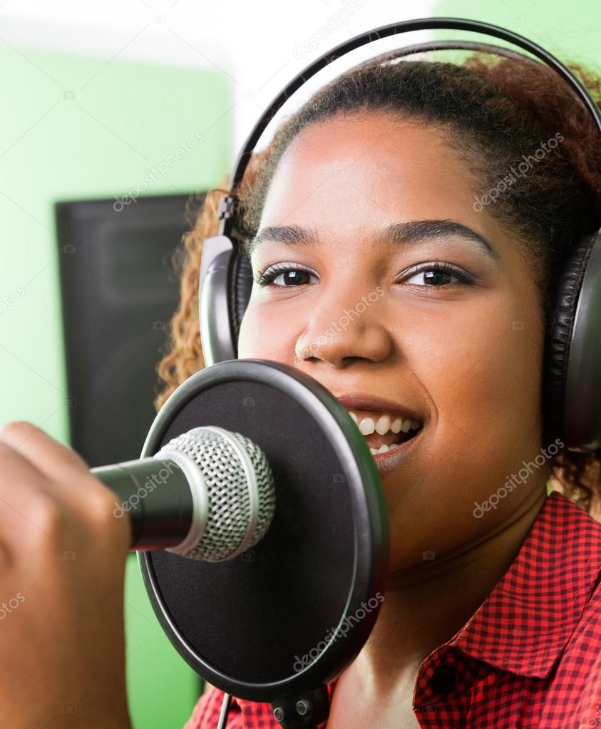 Female Singer Performing In Recording Studio