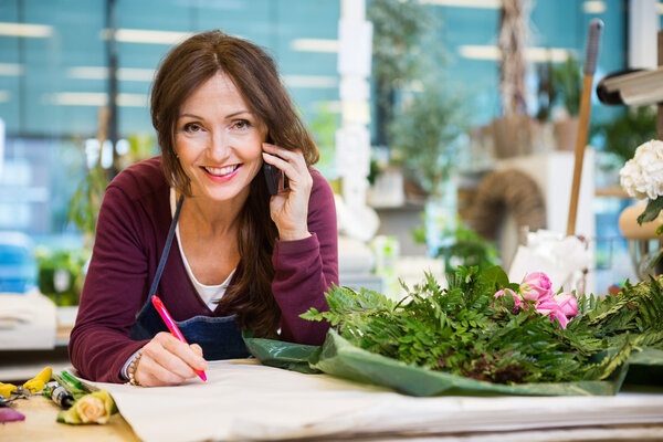 Happy Florist Taking Order In Flower Shop