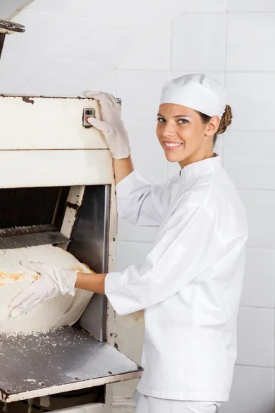 Säker kvinnliga bagare med brödet Slicer på bageriet — Stockfoto