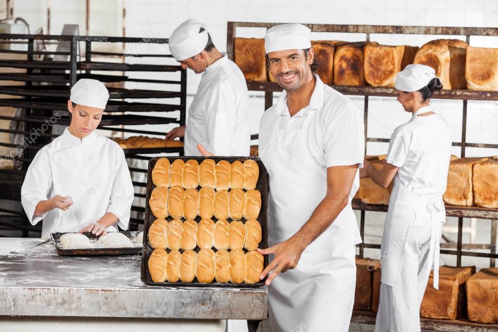 depositphotos_88985366-stock-photo-smile-male-baker-showing-breads.jpg