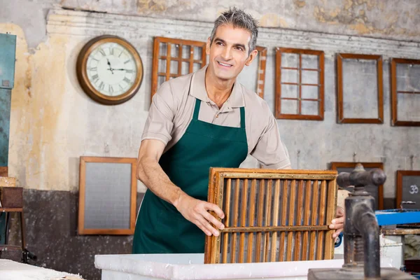 Worker Dipping Mold In Pulp And Water While Looking Away — Stock Photo, Image