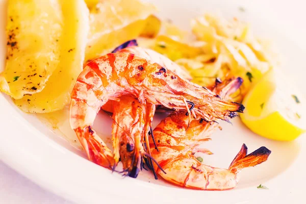 Grilled prawns with potato salad, shallow DOF — Stock Photo, Image