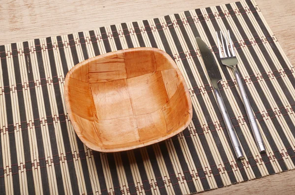 Bowl and cutlery on the table — Stock Photo, Image