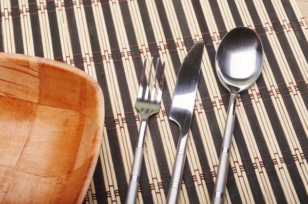 Bowl and cutlery on the table — Stock Photo, Image