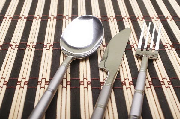Cutlery on placemats — Stock Photo, Image